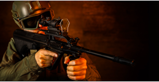 airsoft player holding a rifle with a mounted Black Lion sight guard